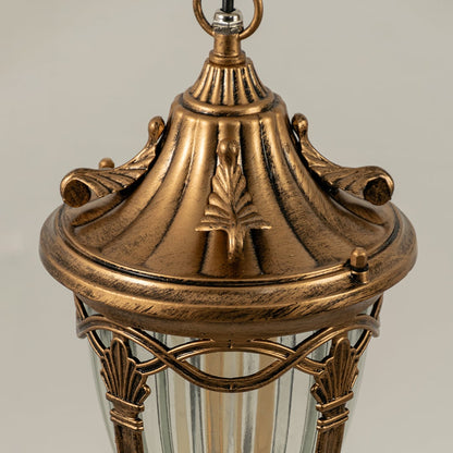 Closeup view of antique gold metal hanging lantern highlighting the ribbed glass shade and elegant outdoor lighting design.