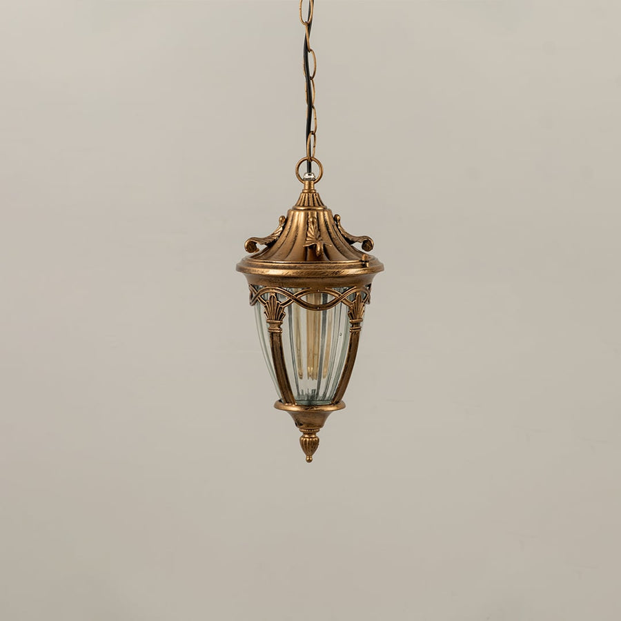 Antique gold metal hanging lantern with ribbed glass shade displayed with lights off for elegant outdoor home decor.