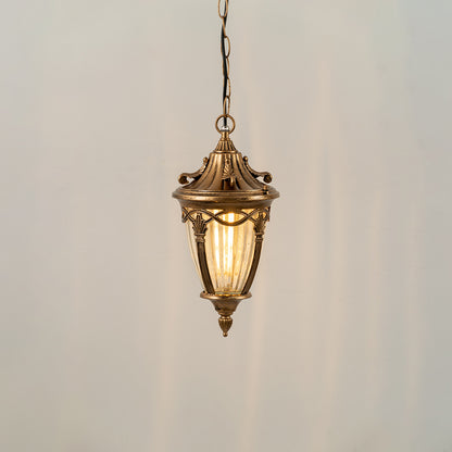 Gold metal hanging outdoor lantern with glass panels glowing on white background ideal for porch entrance and exterior decor lighting.