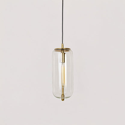 Pendant light with gold finish and clear cylindrical glass shade shown switched off on plain white background.
