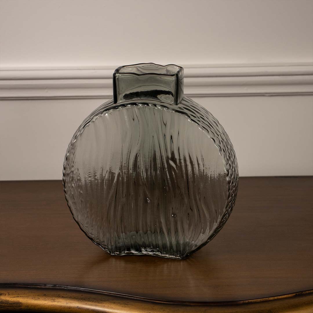Textured round smoke grey glass vase for artistic shelf decor and modern interior design accents in your home.