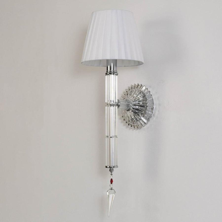 Wall light with chrome base fabric shade and crystal accents turned off on white background for decor.