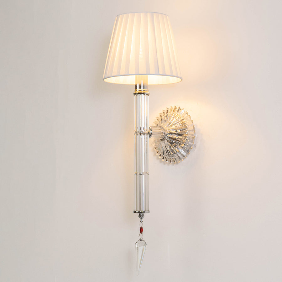 Contemporary metal wall light in chrome finish with fabric shade for bedroom or living room ambient lighting decor placement white background.
