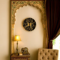 Black pattern wall basket mounted on an ornate beige wall above a side table with lamp and elephant figurine for elegant living room décor.