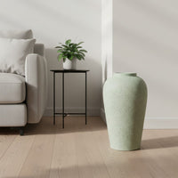 Pastel green floor vase in modern living room for clean minimalist home interior design and serene aesthetic appeal.