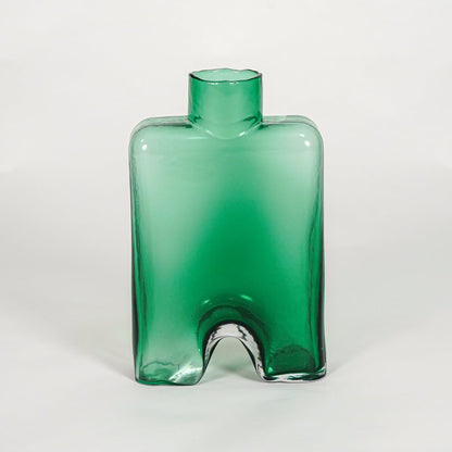 Green decorative art glass vase on white background modern home decor accent piece for table shelf console styling interior.