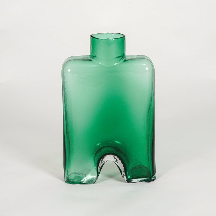 Green decorative art glass vase on white background modern home decor accent piece for table shelf console styling interior.