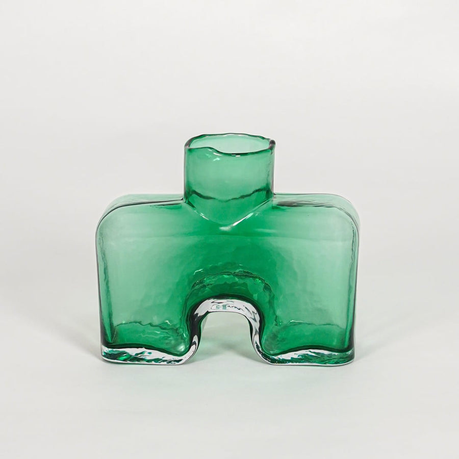 Green decorative art glass vase on white background modern home decor accent piece for table shelf console styling interior.