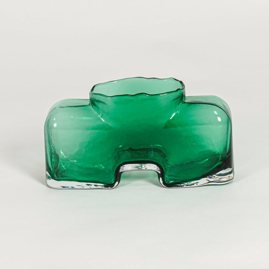 Green decorative art glass vase on white background modern home decor accent piece for table shelf console styling interior.