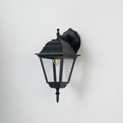 Black wall-mounted lantern light with matte finish and clear glass panels displayed on white background bulb turned off.