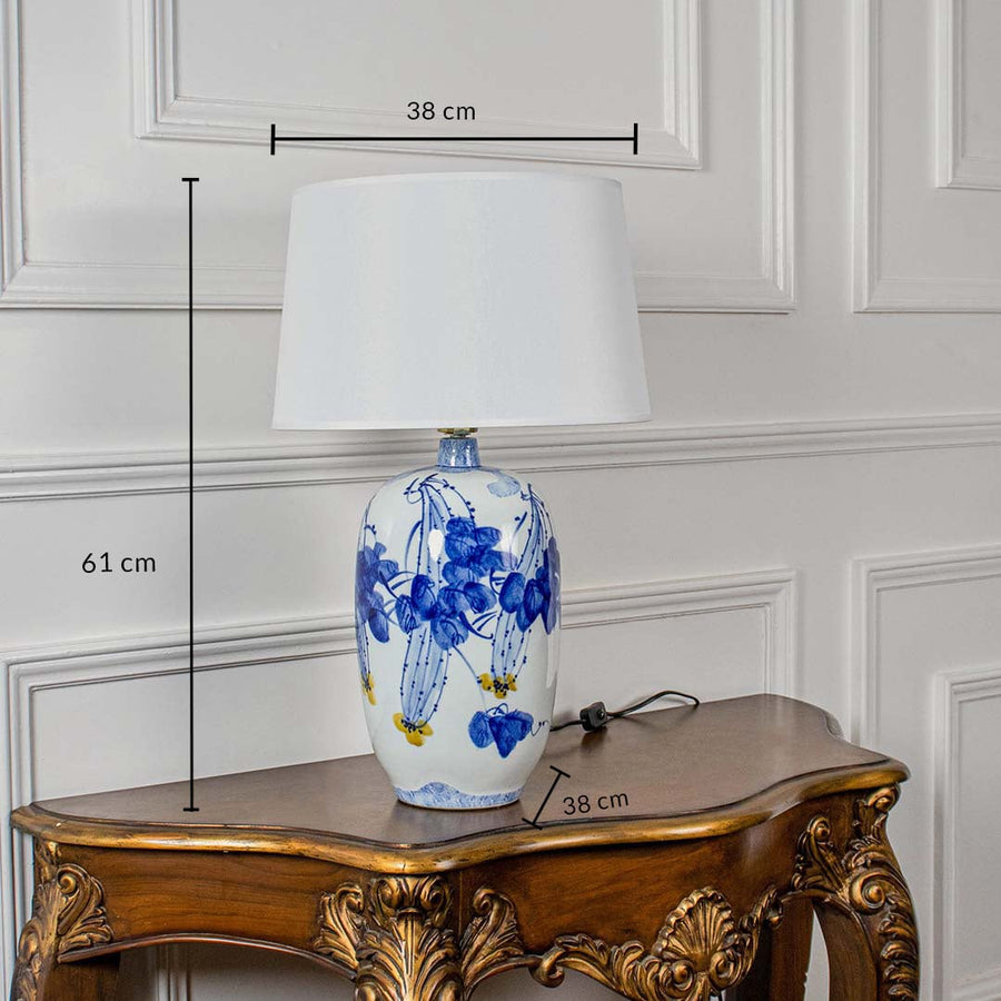 White ceramic table lamp shown with 61 cm height 38 cm shade width and 38 cm base width on a carved wooden console for accurate size reference.