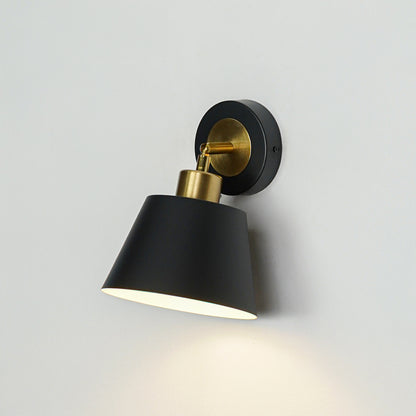 Closeup of black metal wall light with cone shade for modern bedroom hallway and living room decor styling.