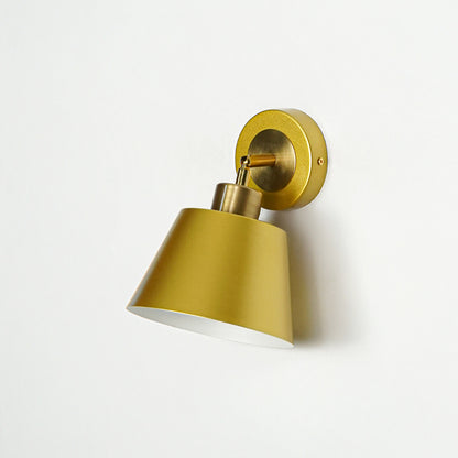 Gold metal wall light with cone shade and round mount ideal for modern bedroom or hallway wall decor placement on clean background.