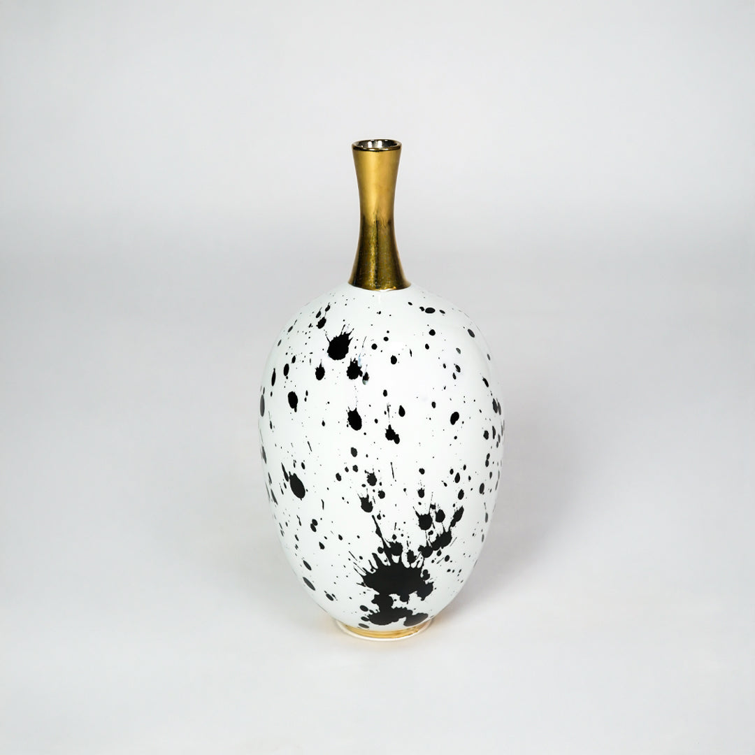 White ceramic vase with gold neck for stylish table placement and modern indoor home decor styling accent piece.