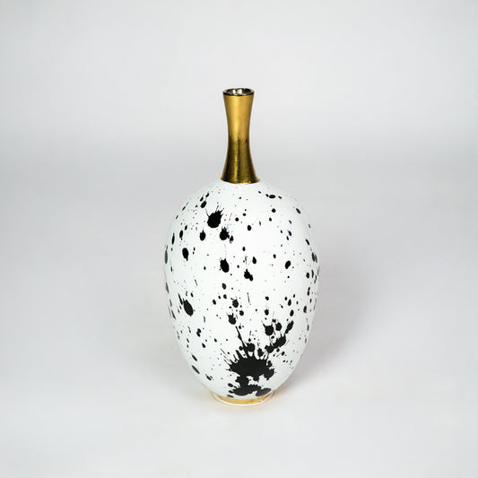 White ceramic vase with gold neck for stylish table placement and modern indoor home decor styling accent piece.