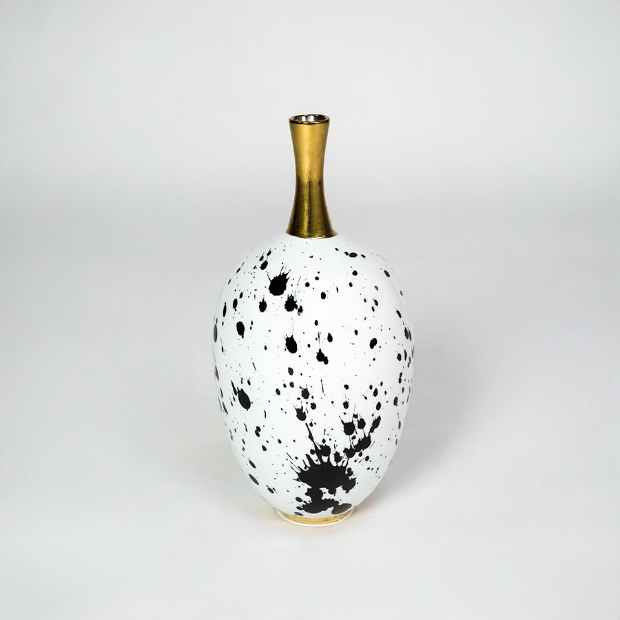 White ceramic vase with gold neck for stylish table placement and modern indoor home decor styling accent piece.