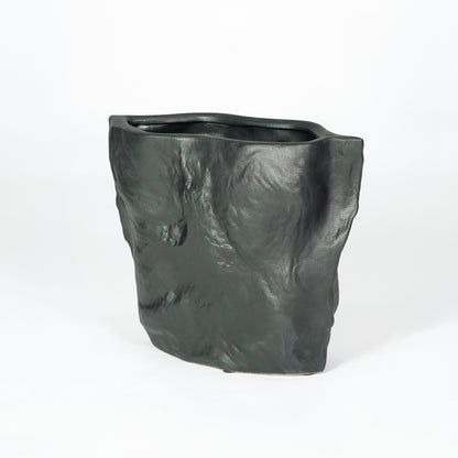 Dark charcoal ceramic planter pot for stylish console table placement and contemporary indoor home decor styling accent piece.