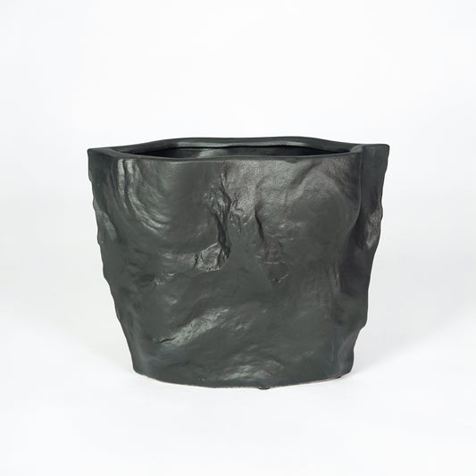 Black textured ceramic planter pot for modern living room shelf styling and elegant indoor table decor display piece art.