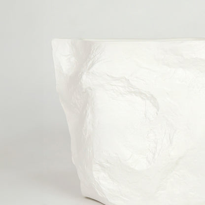 Closeup image of white marble finish abstract decor vase for modern console table styling with elegant texture detail.