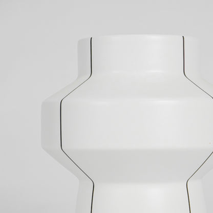 Closeup image of white ceramic geometric vase for modern console table decor with elegant matte finish styling.