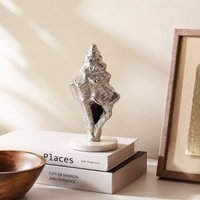 Silver metal decorative figurine for living room console table bookshelf and elegant home decor styling.