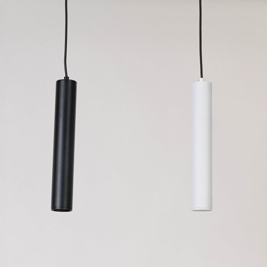 Black tubular pendant lights displayed together on a white background with lights off showing uniform design.