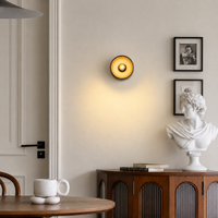 Lifestyle image of gold conduit box metal wall light for elegant hallway decor styling and modern home interior design.