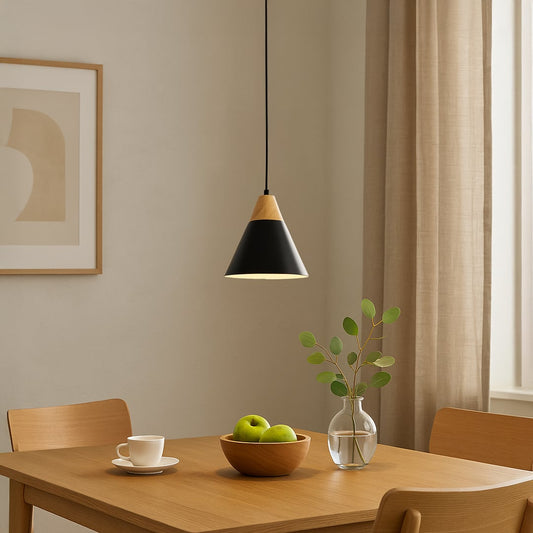 Black and wood pendant light hanging above a dining table creating warm ambient lighting for a modern minimalist dining room interior.