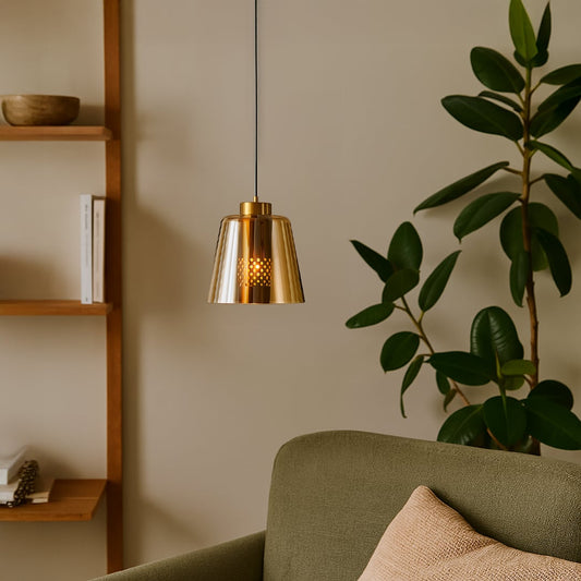 Gold metallic pendant light styled in a modern living room adding warm ambient glow and a sleek contemporary accent to interior decor settings.