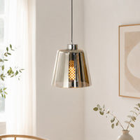 Modern chrome metal pendant light for dining room kitchen island and contemporary home interiors with warm lighting.