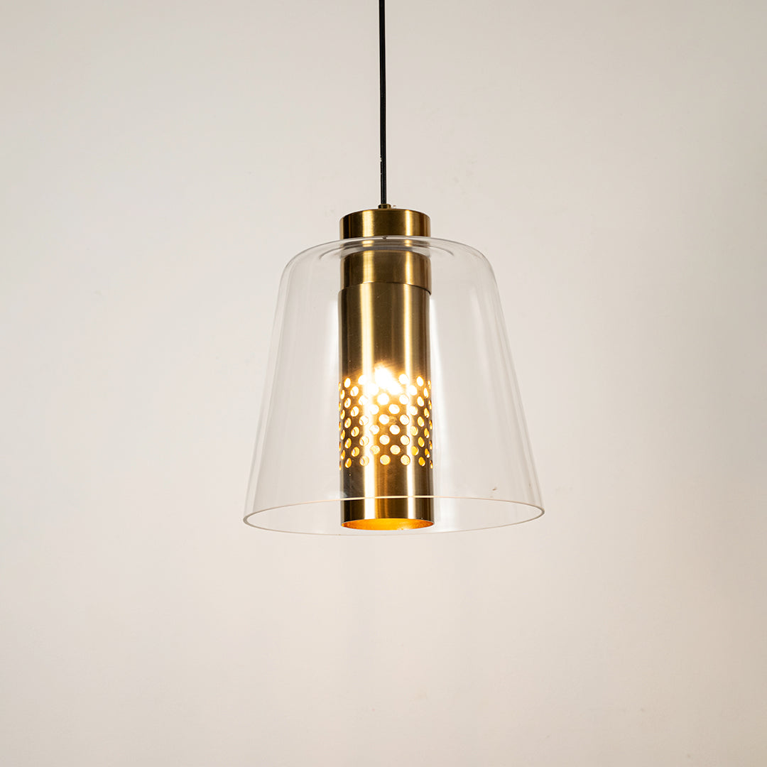 Clear glass pendant light with gold metal finish illuminated beautifully for elegant ceiling lighting decor.