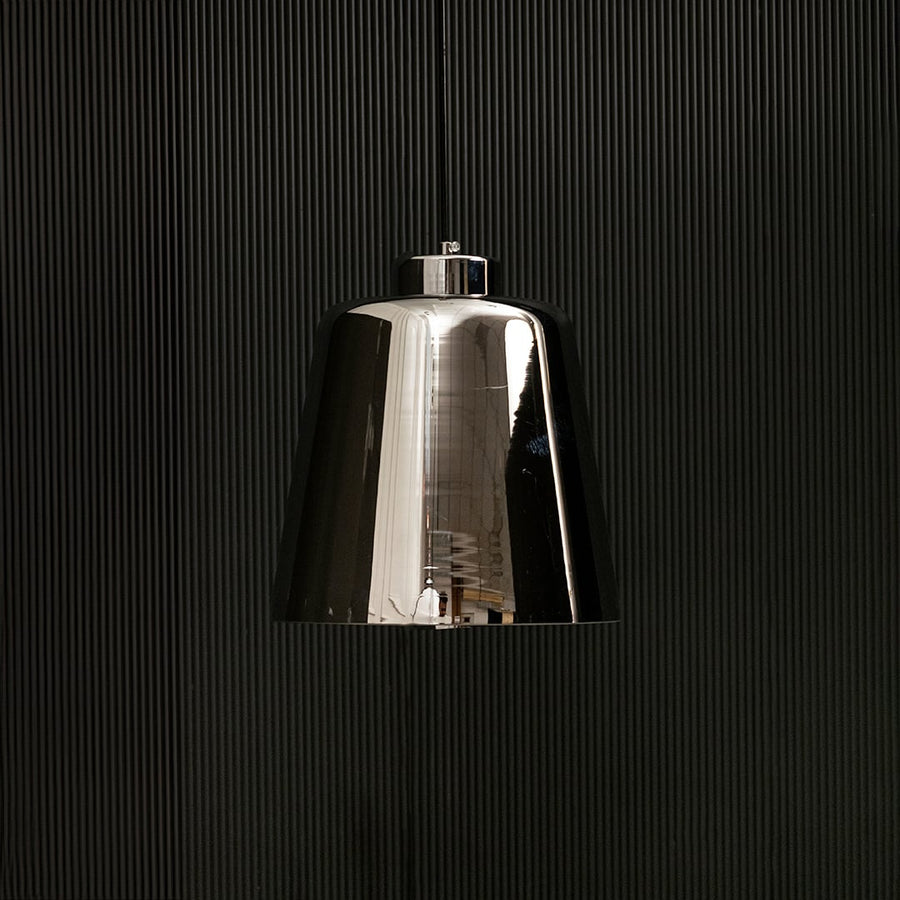 Smoked grey glass pendant light with lights off on black background showing its glossy reflective shade and modern tapered silhouette.