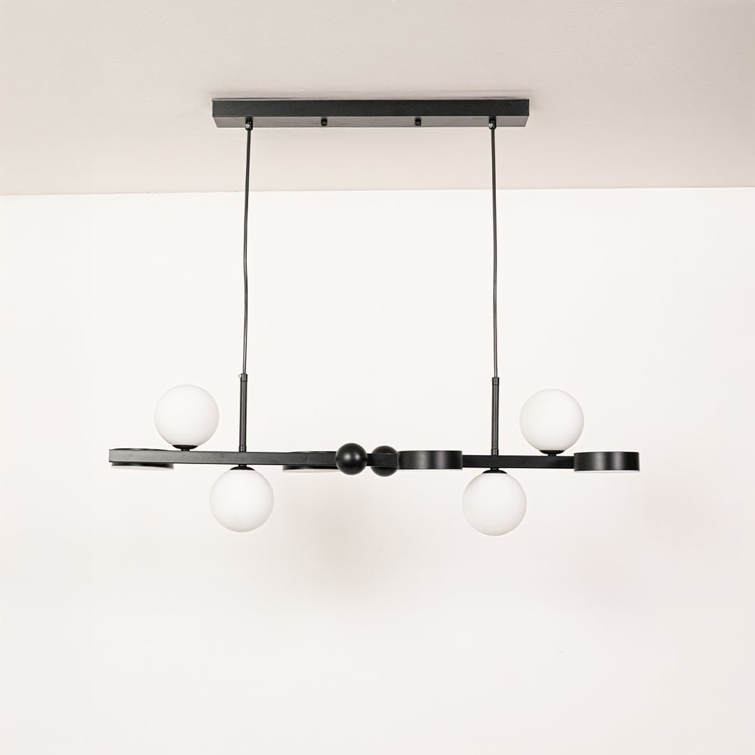 Black metal chandelier with white globe shades displayed with lights off on a clean white background showcasing its modern linear silhouette.