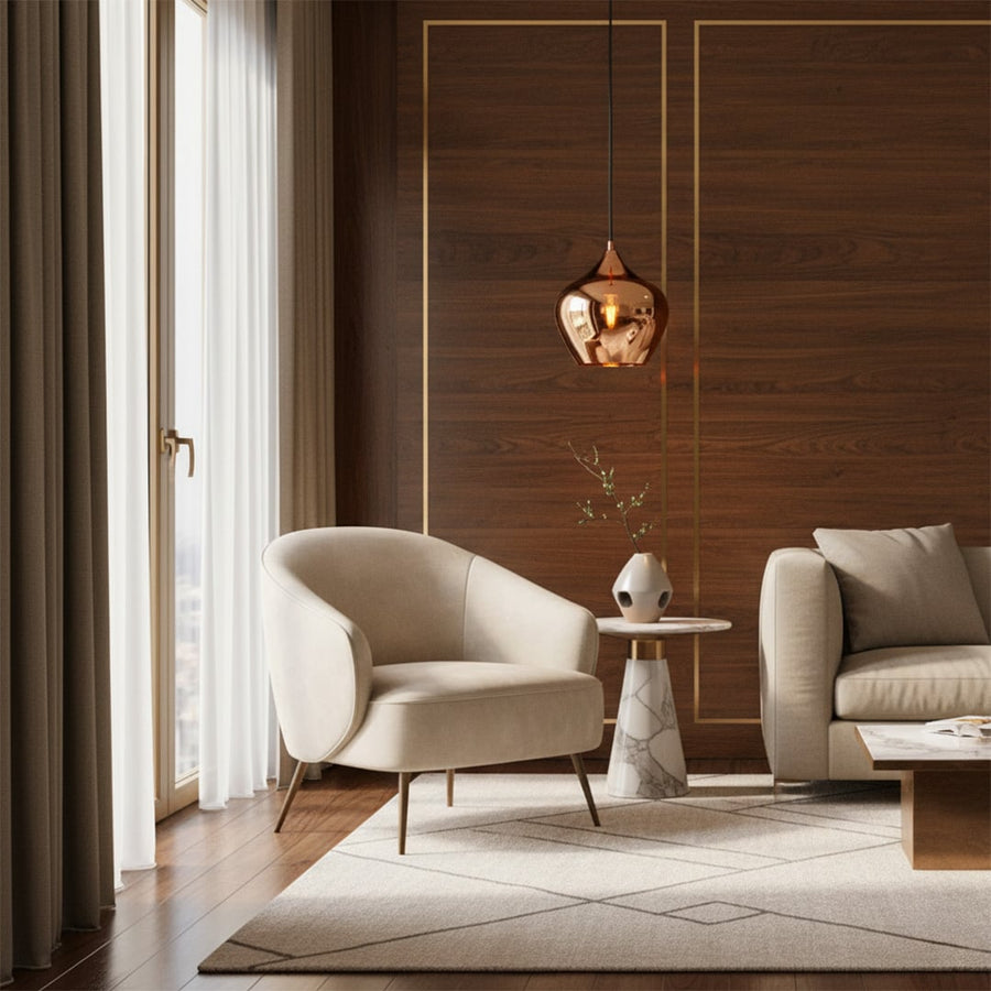 Gold reflective metal pendant light styled in a modern living space adding warm ambient lighting and a sleek contemporary decorative accent.