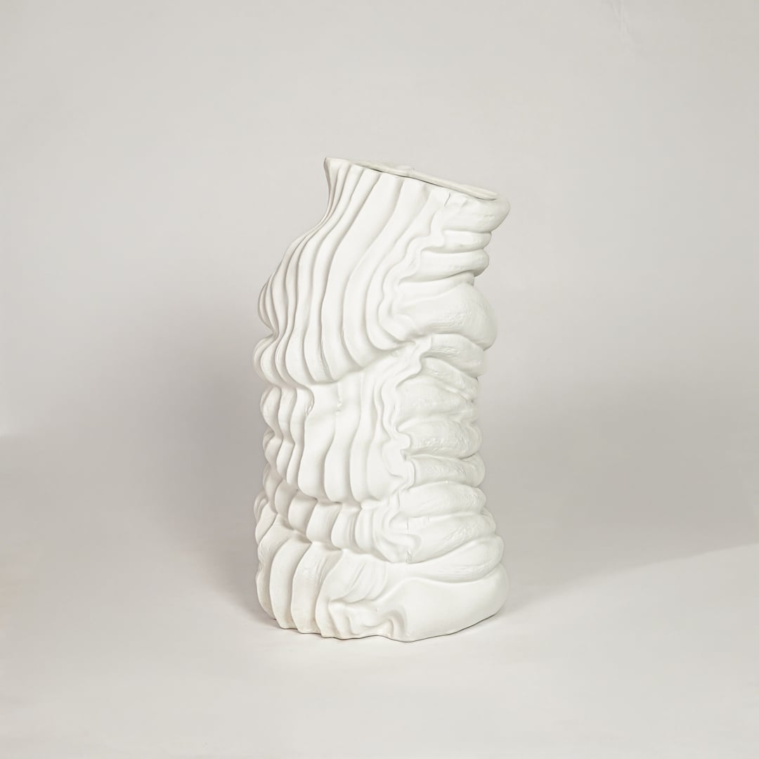 Modern white ceramic sculpted wave design decorative vase ideal for dried floral arrangement in living room corner and home decor styling.