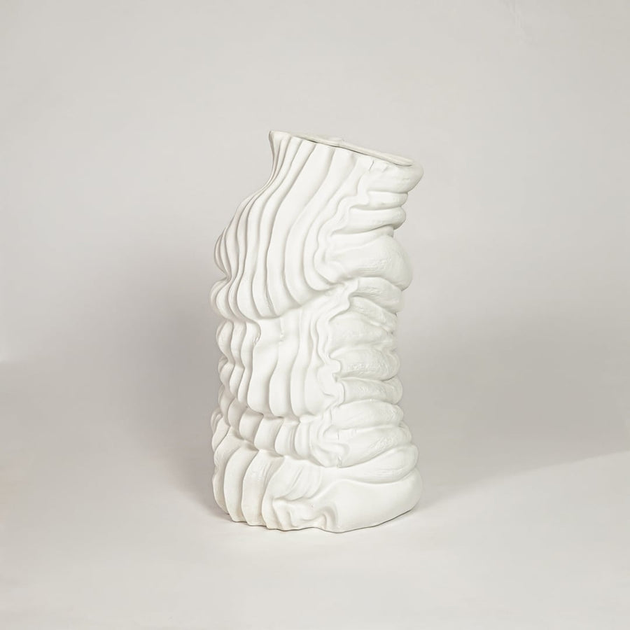 Modern white ceramic sculpted wave design decorative vase ideal for dried floral arrangement in living room corner and home decor styling.