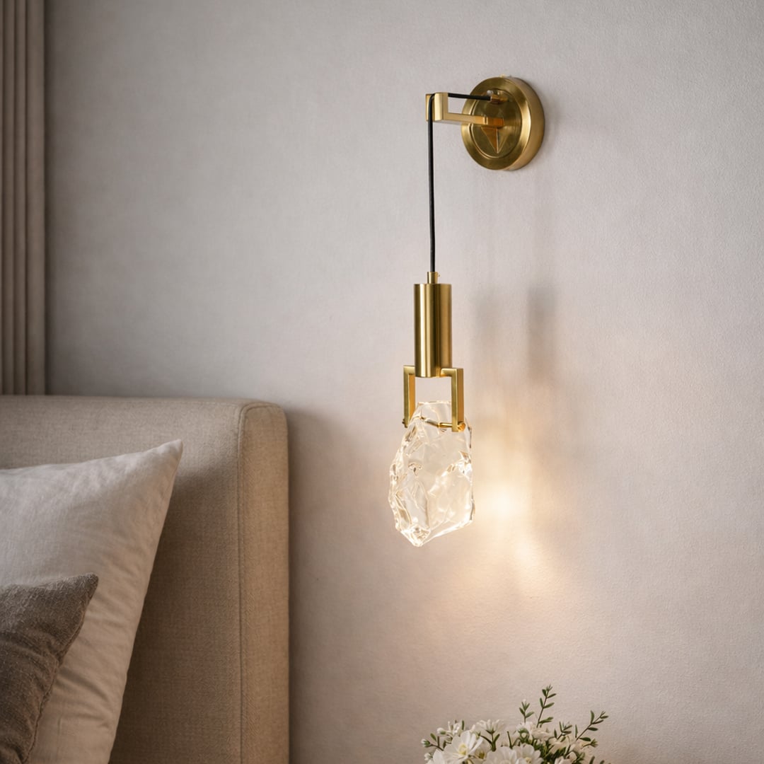 Gold metal wall light with crystal glass shade for elegant modern bedroom lighting and decor styling ideas.