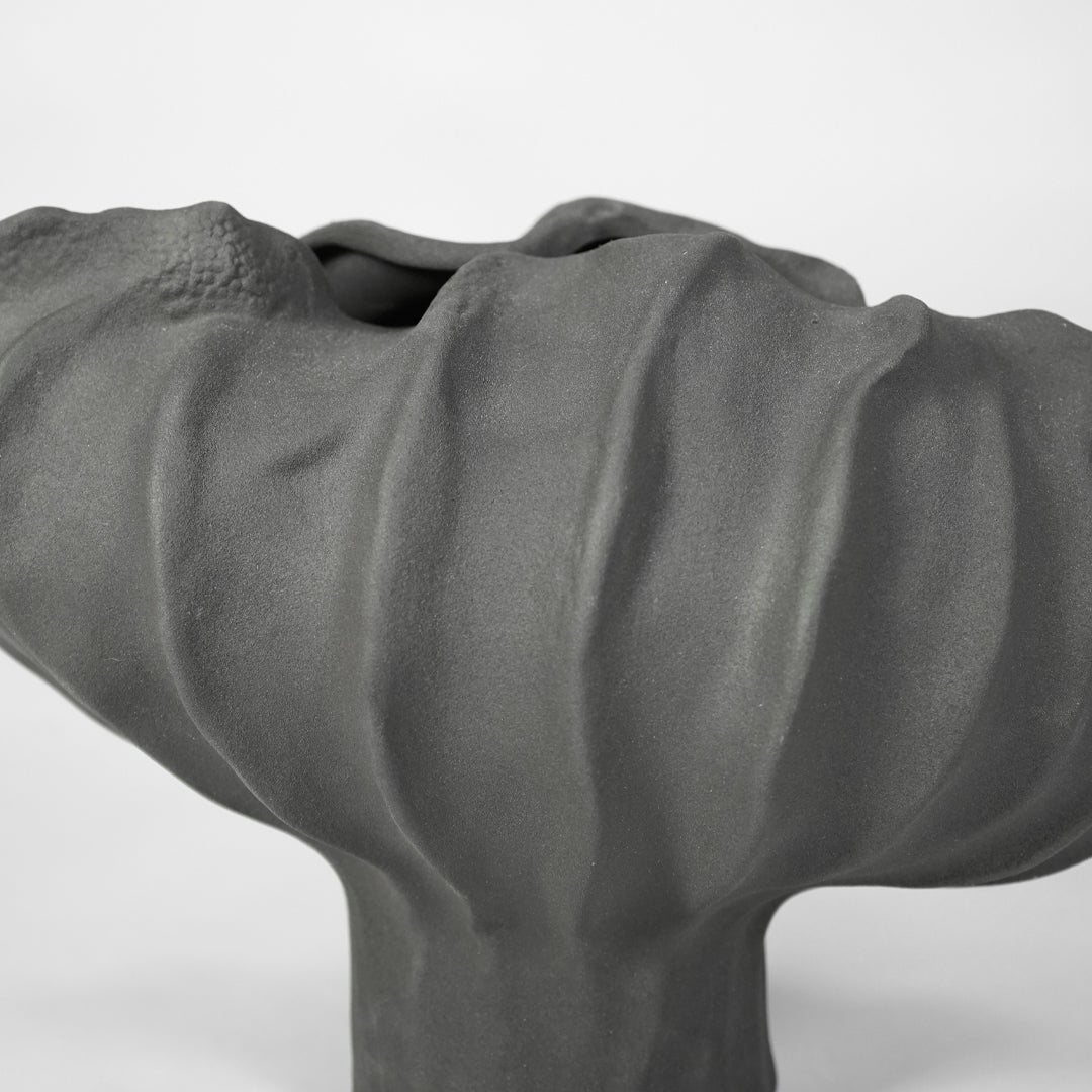 Closeup image of cream ceramic abstract decor sculpture for modern shelf styling with artistic matte finish.