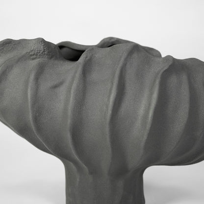 Closeup image of cream ceramic abstract decor sculpture for modern shelf styling with artistic matte finish.