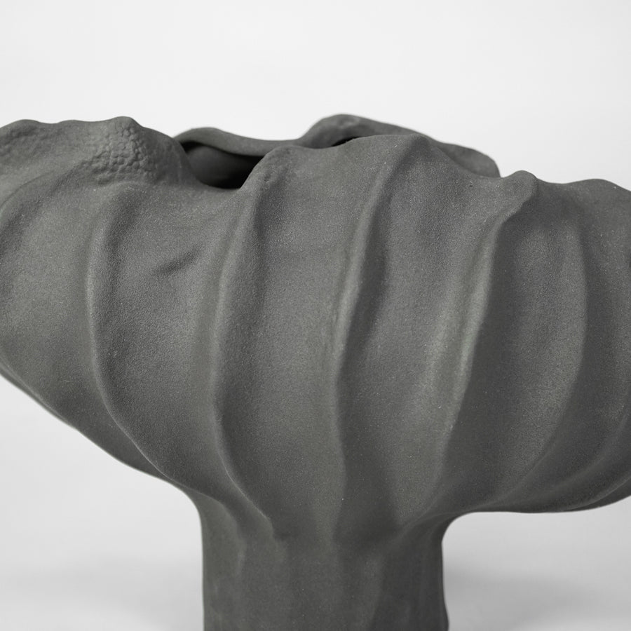 Closeup image of cream ceramic abstract decor sculpture for modern shelf styling with artistic matte finish.