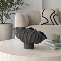Black textured ceramic planter bowl placed on marble table for elegant contemporary home decor styling.