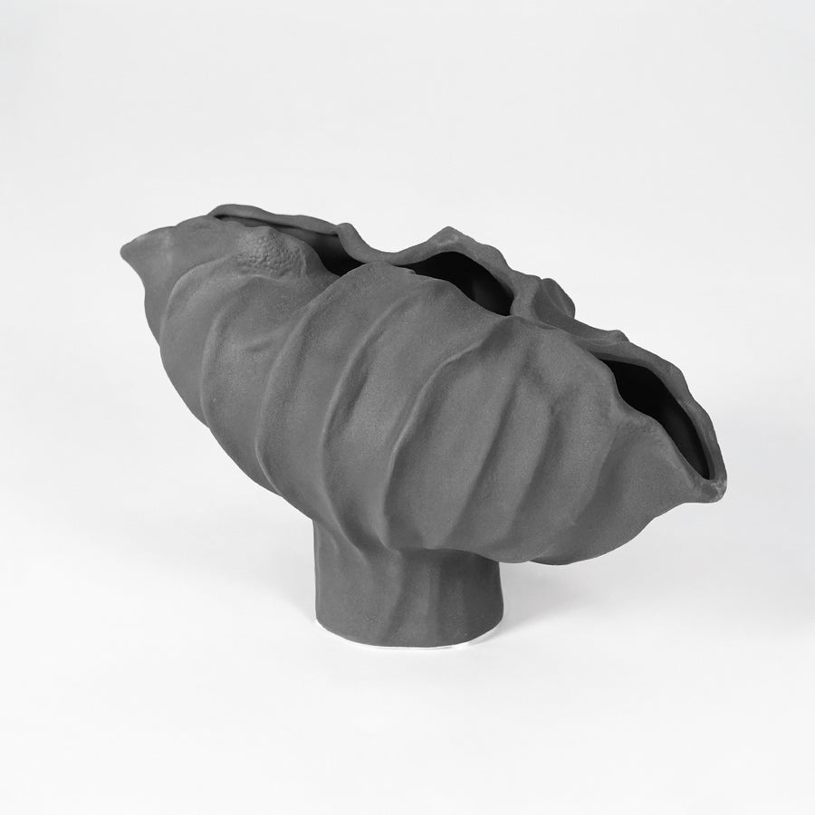 Black sculptural ceramic bowl for modern coffee table placement and elegant indoor home decor styling accent.