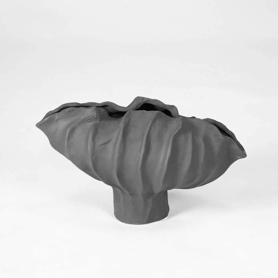 Black sculptural ceramic bowl for stylish coffee table placement and contemporary indoor home decor styling accent.