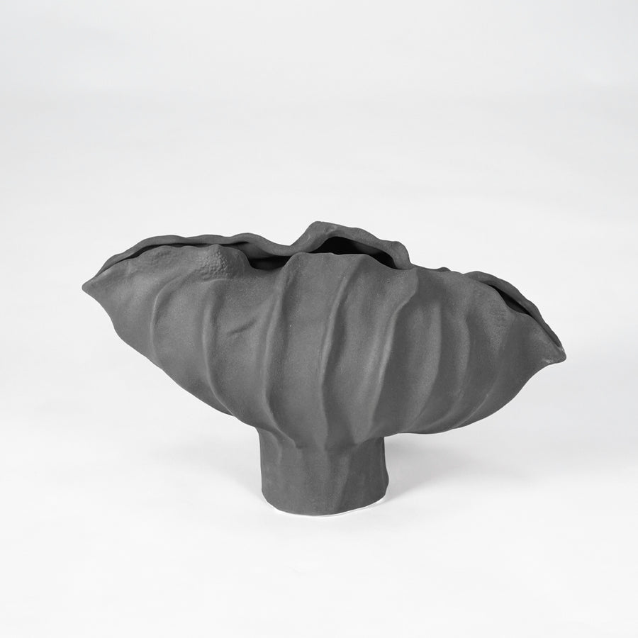 Black sculptural ceramic bowl for stylish coffee table placement and contemporary indoor home decor styling accent.