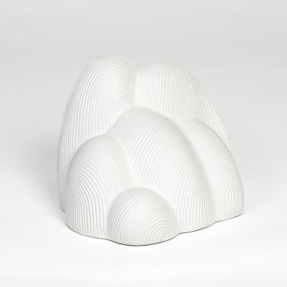 Modern white ceramic statement decor sculpture with curved layered design for minimalist interiors.