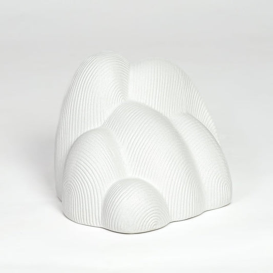 Modern white ceramic statement decor sculpture with curved layered design for minimalist interiors.