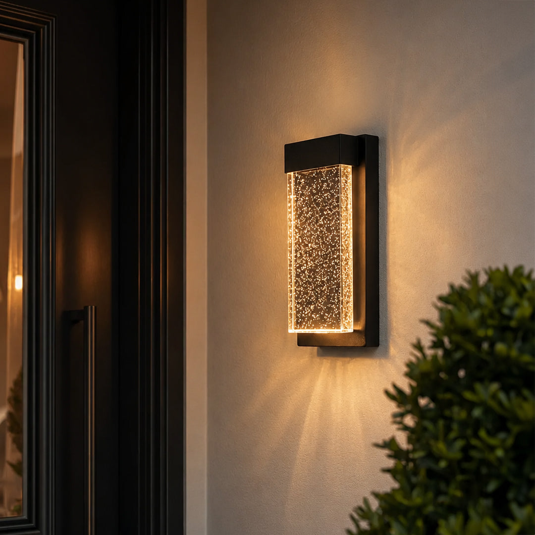 Modern black aluminum outdoor wall sconce lifestyle image with bubbling crystal glass panel for luxury entry decor.