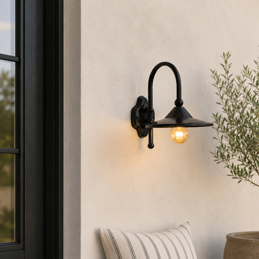Black metal outdoor wall light lifestyle image with exposed bulb for modern patio and exterior decor.