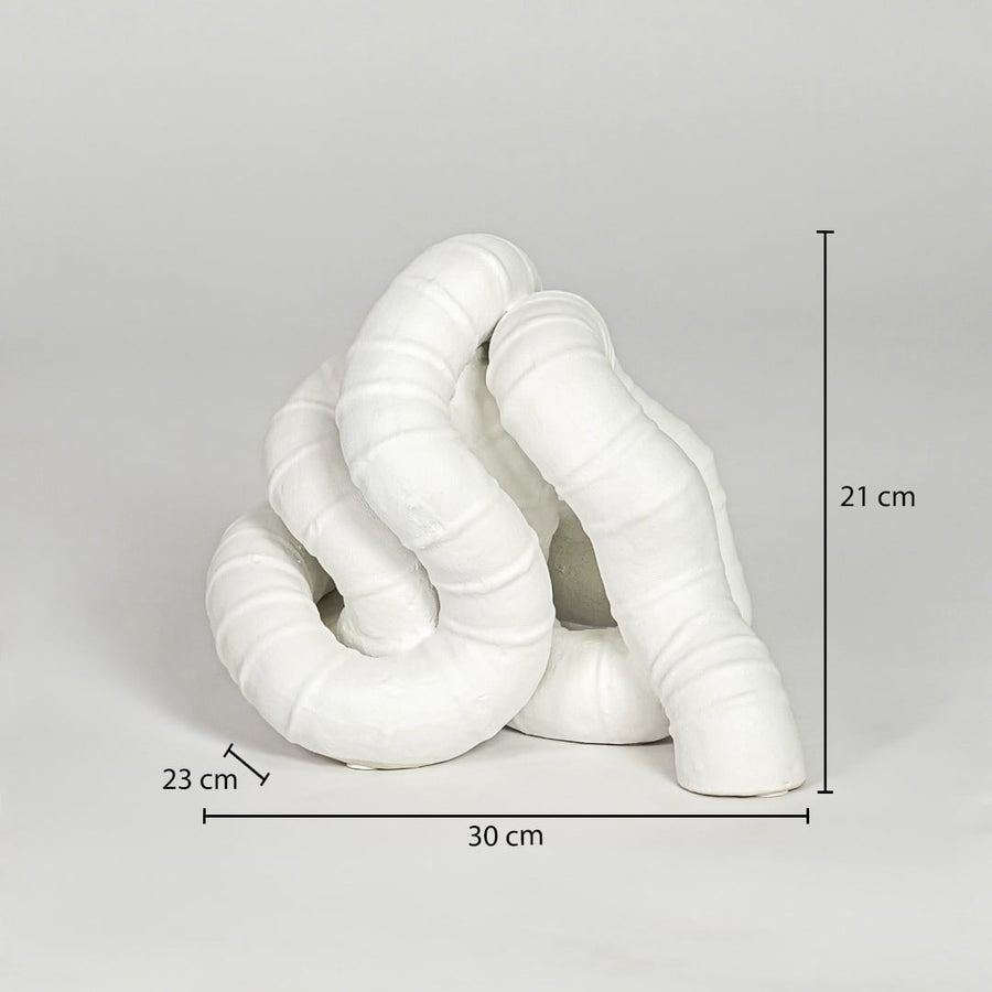 White ceramic abstract decor sculpture size 21 cm height 30 cm width 23 cm depth modern decorative showpiece for table styling.