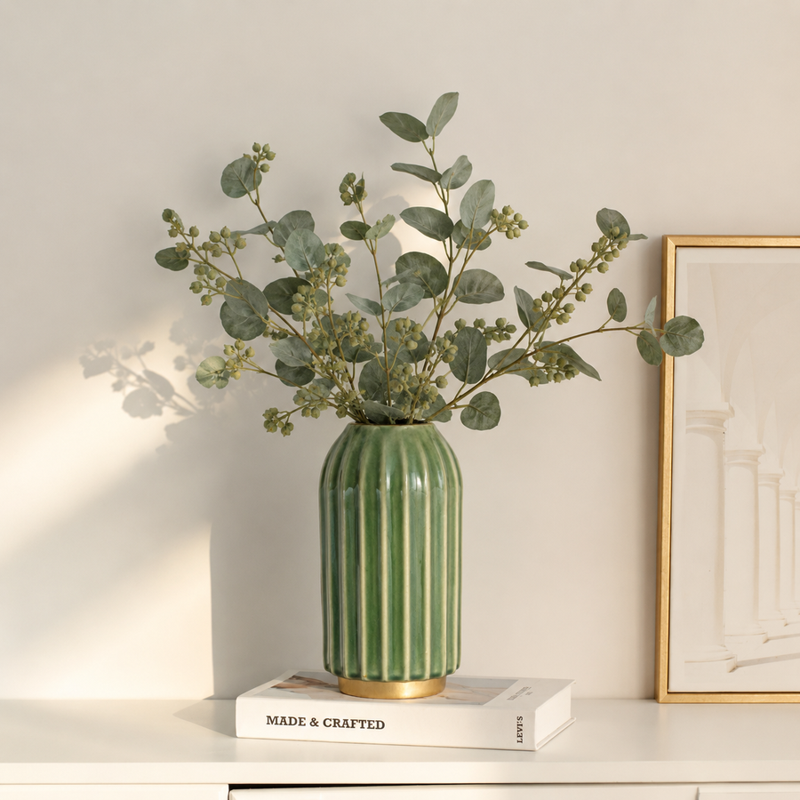 Lifestyle image of green gold ceramic vase for elegant living room decor styling with modern smooth decorative finish.